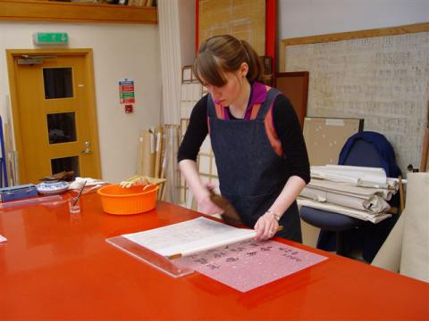 Carol Peacock lining a calligraphy