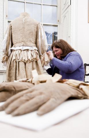 Rosamund mounting the C16 suit of Edmund Verney. Image courtesy National  Trust