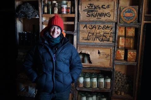 Lizzie Meek inside Cape Royds hut. Image by Alasdair Turner.