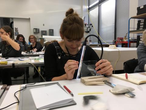 Stephanie positioning glass shards while practising vertical assembly method