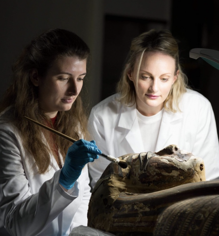 Eleanor, left, working on an Egyptian coffin with a fellow student