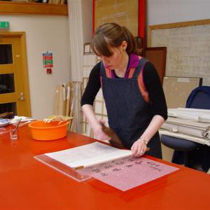 Carol Peacock lining a calligraphy