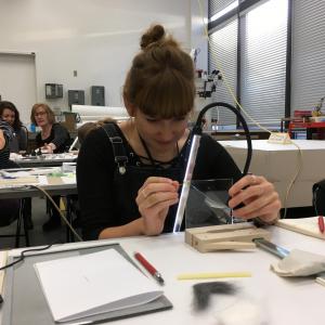 Stephanie positioning glass shards while practising vertical assembly method