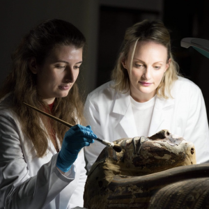 Eleanor, left, working on an Egyptian coffin with a fellow student